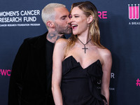 American singer and songwriter Adam Levine of American pop rock band Maroon 5 and wife/Namibian model Behati Prinsloo arrive at The Women's...