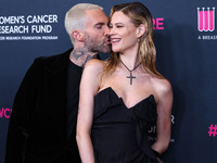 American singer and songwriter Adam Levine of American pop rock band Maroon 5 and wife/Namibian model Behati Prinsloo arrive at The Women's...