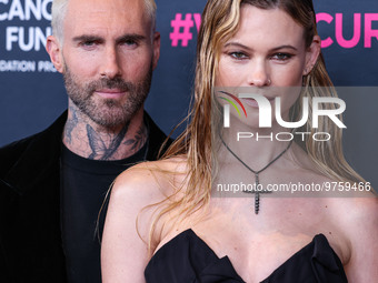 American singer and songwriter Adam Levine of American pop rock band Maroon 5 and wife/Namibian model Behati Prinsloo arrive at The Women's...