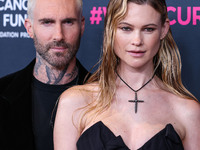 American singer and songwriter Adam Levine of American pop rock band Maroon 5 and wife/Namibian model Behati Prinsloo arrive at The Women's...