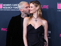 American singer and songwriter Adam Levine of American pop rock band Maroon 5 and wife/Namibian model Behati Prinsloo arrive at The Women's...