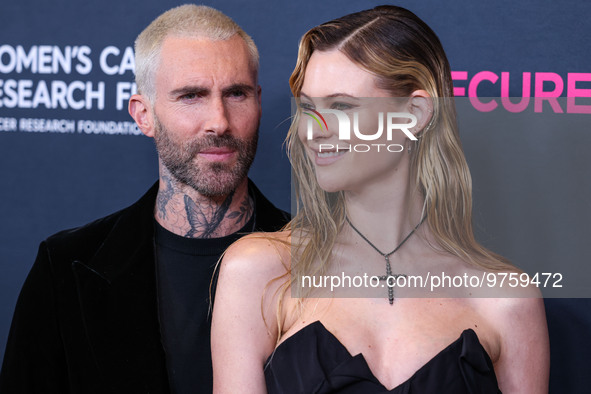 American singer and songwriter Adam Levine of American pop rock band Maroon 5 and wife/Namibian model Behati Prinsloo arrive at The Women's...