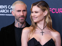 American singer and songwriter Adam Levine of American pop rock band Maroon 5 and wife/Namibian model Behati Prinsloo arrive at The Women's...