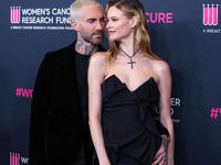 American singer and songwriter Adam Levine of American pop rock band Maroon 5 and wife/Namibian model Behati Prinsloo arrive at The Women's...