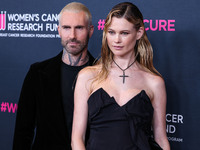 American singer and songwriter Adam Levine of American pop rock band Maroon 5 and wife/Namibian model Behati Prinsloo arrive at The Women's...