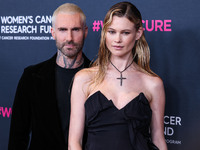 American singer and songwriter Adam Levine of American pop rock band Maroon 5 and wife/Namibian model Behati Prinsloo arrive at The Women's...