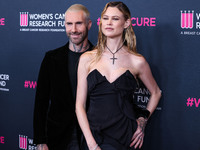 American singer and songwriter Adam Levine of American pop rock band Maroon 5 and wife/Namibian model Behati Prinsloo arrive at The Women's...