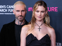 American singer and songwriter Adam Levine of American pop rock band Maroon 5 and wife/Namibian model Behati Prinsloo arrive at The Women's...