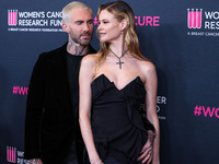 American singer and songwriter Adam Levine of American pop rock band Maroon 5 and wife/Namibian model Behati Prinsloo arrive at The Women's...