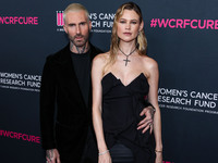 American singer and songwriter Adam Levine of American pop rock band Maroon 5 and wife/Namibian model Behati Prinsloo arrive at The Women's...