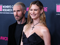 American singer and songwriter Adam Levine of American pop rock band Maroon 5 and wife/Namibian model Behati Prinsloo arrive at The Women's...