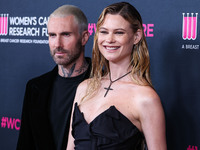 American singer and songwriter Adam Levine of American pop rock band Maroon 5 and wife/Namibian model Behati Prinsloo arrive at The Women's...