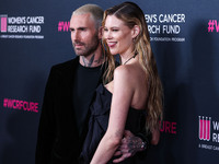 American singer and songwriter Adam Levine of American pop rock band Maroon 5 and wife/Namibian model Behati Prinsloo arrive at The Women's...