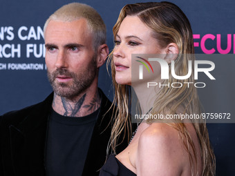 American singer and songwriter Adam Levine of American pop rock band Maroon 5 and wife/Namibian model Behati Prinsloo arrive at The Women's...