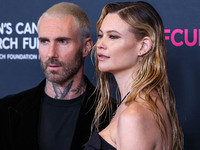 American singer and songwriter Adam Levine of American pop rock band Maroon 5 and wife/Namibian model Behati Prinsloo arrive at The Women's...