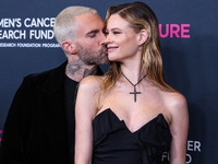 American singer and songwriter Adam Levine of American pop rock band Maroon 5 and wife/Namibian model Behati Prinsloo arrive at The Women's...