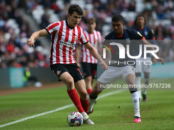 Sunderland's Luke O'Nien is under pressure from Luton Town's Cody Drameh during the Sky Bet Championship match between Sunderland and Luton...