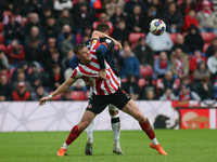 Sunderland's Daniel Ballard challenges Luton Town's Carlton Morris during the Sky Bet Championship match between Sunderland and Luton Town a...