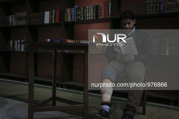 Nur reads a book in the hair Nizar Qabbani paper in the cultural center in the city of Aleppo on December 29,2015 .Nour lost his leg followi...