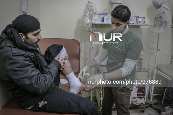 Nour, a 18-year-old Syrian man, helps a wounded man in a hospital, in a rebel-controlled area of Aleppo, on December 29, 2015. Nour lost his...