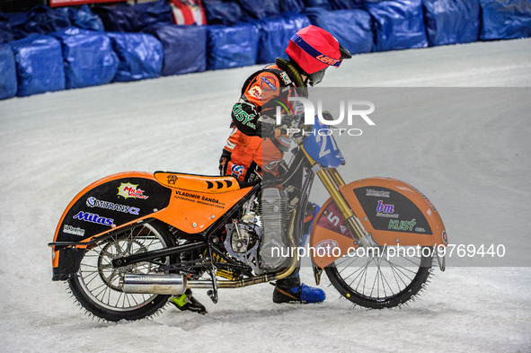 Lukas Hutla (212) walks his bike off the track after his fall during the Ice Speedway Gladiators World Championship Final 1 at Max-Aicher-Ar...