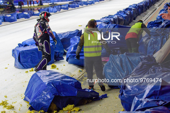 Benedikt Monn (17) (Reserve) goes to retrieve his machine after coming off  during the Ice Speedway Gladiators World Championship Final 1 at...