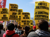 Demonstrators march in Washington, D.C. on March 18, 2023 during an anti-war protest organized by the Answer Coalition and dozens of other g...