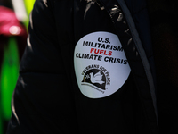 A demonstrator wears a sticker during an anti-war protest in Washington, D.C. on March 18, 2023. The protest, organized by the Answer Coalit...