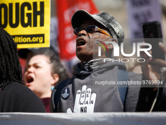 Demonstrators march in Washington, D.C. on March 18, 2023 during an anti-war protest organized by the Answer Coalition and dozens of other g...