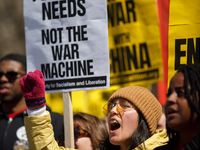 Demonstrators march in Washington, D.C. on March 18, 2023 during an anti-war protest organized by the Answer Coalition and dozens of other g...