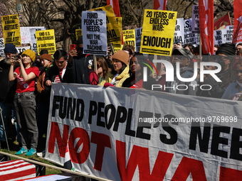 Demonstrators march in Washington, D.C. on March 18, 2023 during an anti-war protest organized by the Answer Coalition and dozens of other g...