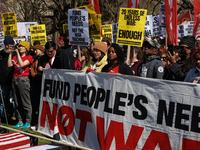 Demonstrators march in Washington, D.C. on March 18, 2023 during an anti-war protest organized by the Answer Coalition and dozens of other g...