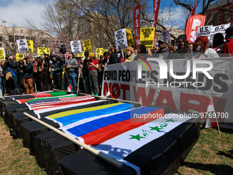 Demonstrators march in Washington, D.C. on March 18, 2023 during an anti-war protest organized by the Answer Coalition and dozens of other g...