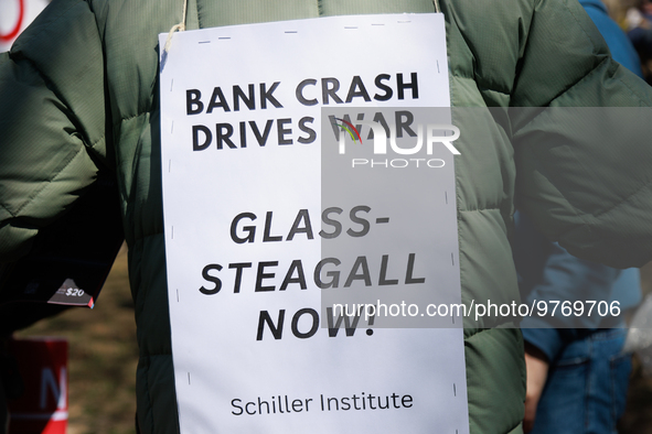 A demonstrator wears a sign during an anti-war protest in Washington, D.C. on March 18, 2023. The protest, organized by the Answer Coalition...