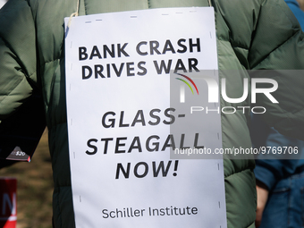 A demonstrator wears a sign during an anti-war protest in Washington, D.C. on March 18, 2023. The protest, organized by the Answer Coalition...