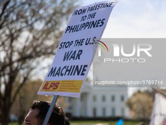 A demonstrator holds a sign during an anti-war protest in Washington, D.C. on March 18, 2023. The protest, organized by the Answer Coalition...