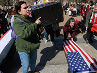 Demonstrators place symbolic body caskets on the ground in front of the White House during an anti-war protest in Washington, D.C. on March...