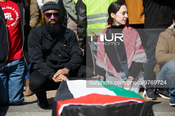 Demonstrators place symbolic body caskets on the ground in front of the White House during an anti-war protest in Washington, D.C. on March...