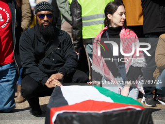 Demonstrators place symbolic body caskets on the ground in front of the White House during an anti-war protest in Washington, D.C. on March...