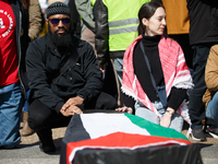 Demonstrators place symbolic body caskets on the ground in front of the White House during an anti-war protest in Washington, D.C. on March...