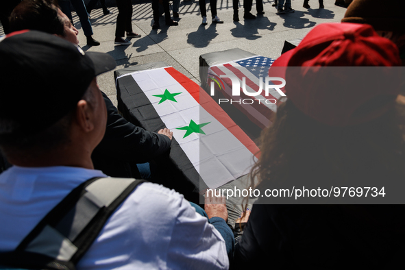 Demonstrators place symbolic body caskets on the ground in front of the White House during an anti-war protest in Washington, D.C. on March...