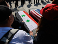 Demonstrators place symbolic body caskets on the ground in front of the White House during an anti-war protest in Washington, D.C. on March...