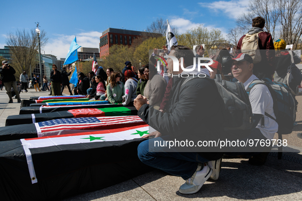 Demonstrators place symbolic body caskets on the ground in front of the White House during an anti-war protest in Washington, D.C. on March...