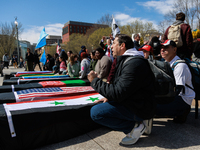 Demonstrators place symbolic body caskets on the ground in front of the White House during an anti-war protest in Washington, D.C. on March...