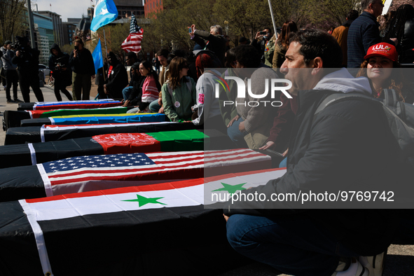 Demonstrators place symbolic body caskets on the ground in front of the White House during an anti-war protest in Washington, D.C. on March...