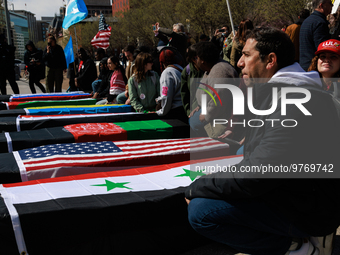 Demonstrators place symbolic body caskets on the ground in front of the White House during an anti-war protest in Washington, D.C. on March...