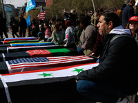 Demonstrators place symbolic body caskets on the ground in front of the White House during an anti-war protest in Washington, D.C. on March...