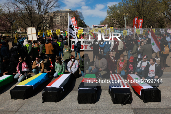 Demonstrators place symbolic body caskets on the ground in front of the White House during an anti-war protest in Washington, D.C. on March...