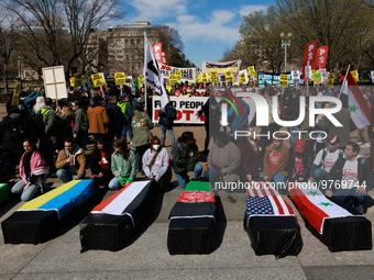 Demonstrators place symbolic body caskets on the ground in front of the White House during an anti-war protest in Washington, D.C. on March...