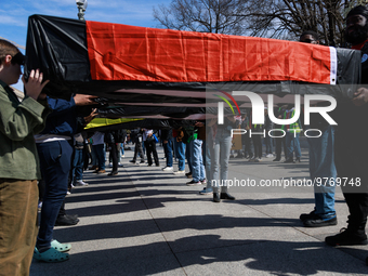 Demonstrators carry symbolic body caskets after placing them on the ground in front of the White House during an anti-war protest in Washing...